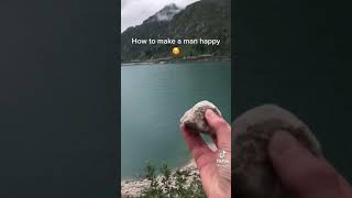 Man Throws Rock In Water From High Up