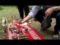 Shaman gives Anthony Bourdain a spritiual bath.