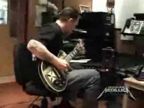 Robert Trujillo playing an acouistic guitar