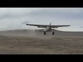 Cessna 180 landing short in windy conditions.