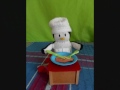 Percy Wett, the knitted penguin does some cooking.