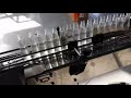 Video 140ml PET bottle unscrambler filler rotary capper sleeve labeler machine liquid bottling line