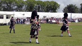 Drum Major's Mace Floursh Display during Oldmeldrum Highland Games in Aberdeenshire, Scotland 2019