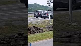 Unmarked Chevy Tahoe Police Cruiser Taking Off From A Green Light