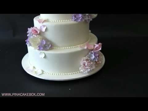  This nut free 4 tier round wedding cake is decorated with cascading pink 