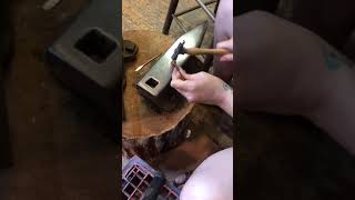 Hammering a copper cocktail pick with mini spoon end