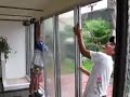 Installing glass doors for Shipping Container Home, a small portable tiny home in Costa Rica