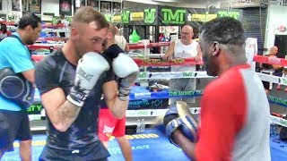 Amateur boxer hitting pads with Jeff Mayweather inside the Mayweather Boxing Club