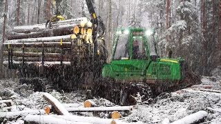 Fully loaded John Deere 1110E in wet snowy winter forest conditions