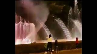 Funny lady conducting a musical water fountain.. LOL