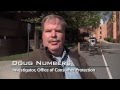Investigator Doug Numbers reviews a car repair warranty case with consumers