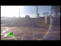 CCTV video: Near miss for man crossing train tracks in Australia