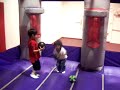 Kavin playing basket ball in bounce house