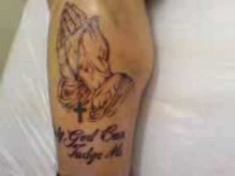 And thanks to the rosary tattoo he has, he never will. praying hands tattoo