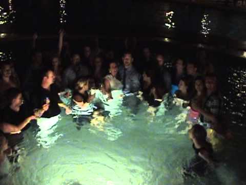 Wedding party and guests in the hot tub in dress clothes