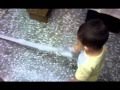 A 1 years old children uses vacuum cleaner