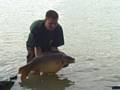 A carp is released back into Lake Madine.