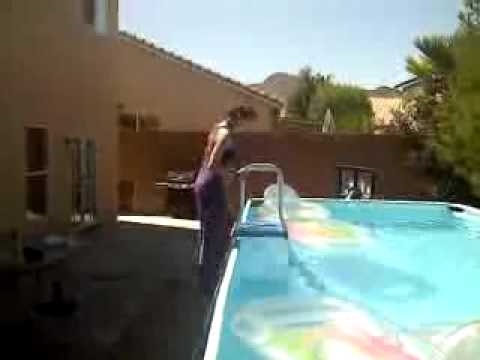 girl jumping in a pool with her p jays