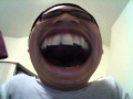 Fat asian guy laughs over webcam effects