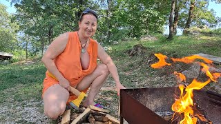 Wood cutting  Mila. cooking on an open fire. Mila's Naturist Cooking. Mila natur