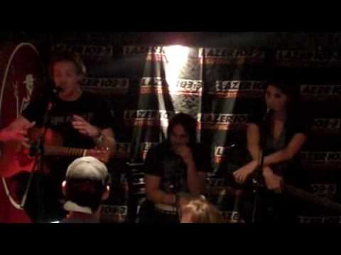 Lazer 103.3's Andy Hall interviews the Sick Puppies between songs at a Lazer 103.3's Andy Hall interviews the Sick Puppies between songs at a