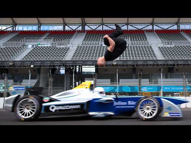 Daredevil Backflips Over Speeding Formula Race Car - Video