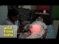 Indian hijra injects insulin into her mother's thigh