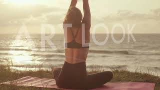 Young Girl Doing Yoga By The Sea