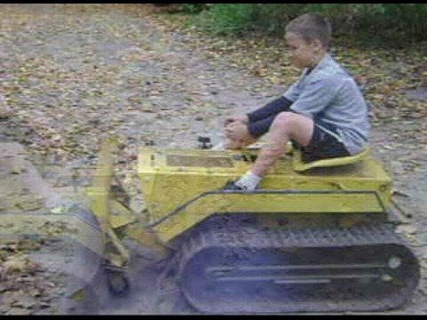 johnny and his sister driving the mini dozer he got for his birthday.