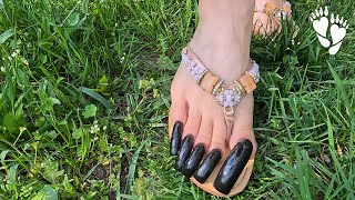 Demo Walking On The Gr With Long Black Toenails