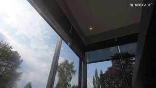 Perfectly Aligned Electric Roller Shades in Corner Windows - Hidden When Not Required