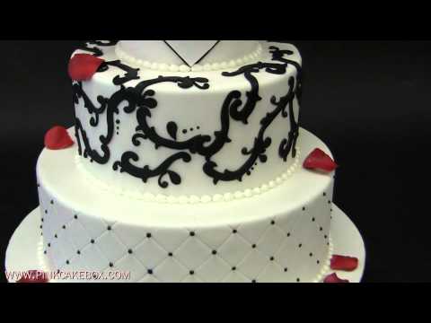 This 3 tier round wedding cake is covered in white fondant and topped with