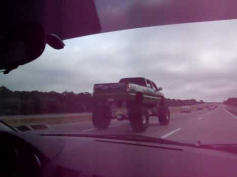 Huge Monster Truck driving on a highway alongside my car ...