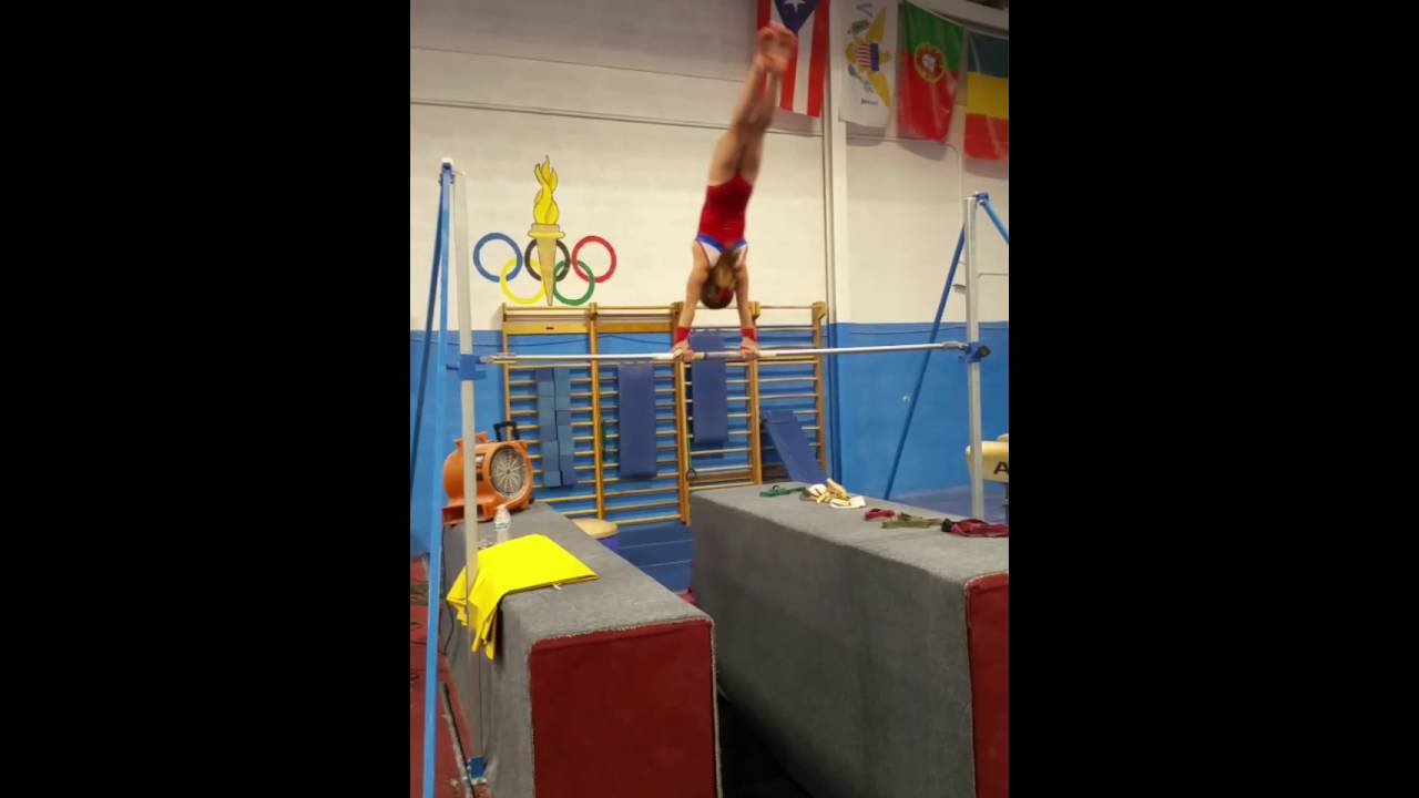 7 year old gymnast Abigail Harvey giants on strap bar Gymnastics Club