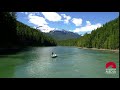 Aerial of men fishing in river mountain landscape | WaveBreak Media