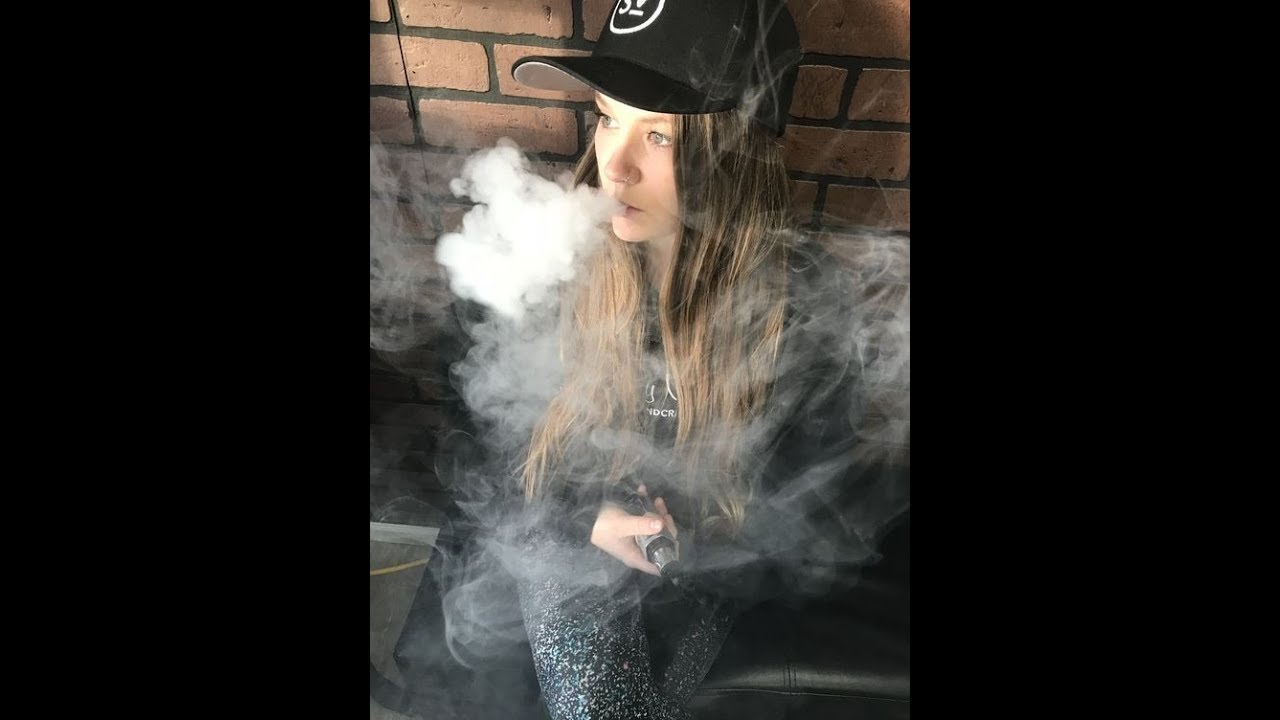 During facesitting girl smokes vape