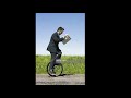 Guy Rides Unicycle While Reading Newspaper!