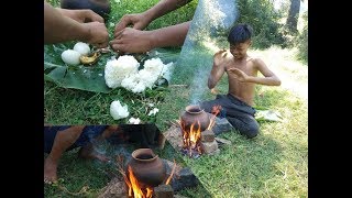 Primitive Technology - Two boys are eating eggs with rice