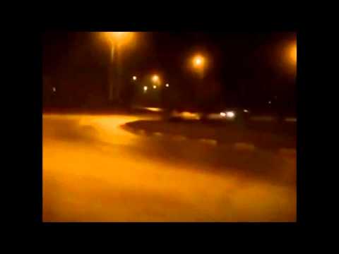 Toyota Supra drifting around a roundabout infront of cops