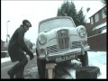 Changing the tyre on our Wolseley Hornet in the snow.