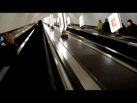 Riding up the long escalator at Arsenalna Metro station, Kyiv Metro, Ukraine
