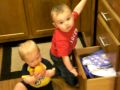 Connor playing with the cabinets with Declan - 10 months