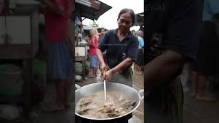 Middle-Aged Woman Cooking Monitor Lizard Rib Soup In A Busy Slum Market. -Ai
