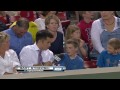 Boy hands souvenir over to girl behind him