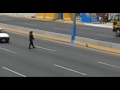 Policeman stops traffic to save a frightened dog stuck on the freeway