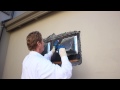 Repair an exterior patch in a stucco wall caused by stove pipe vents.