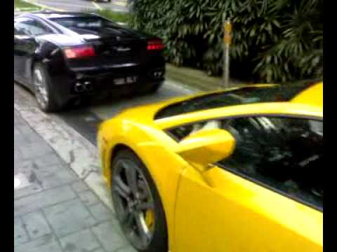 2 Lamborghini LP5604 black and yellow parked at the valet parking of
