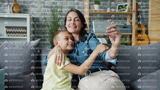 Happy Mother And Son Posing For Smartphone Camera Hugging Smiling Taking Selfie