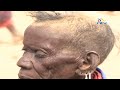 Turkana woman breastfeeds orphaned goat