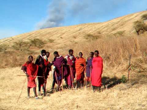 Masai jumping dance in front of erupting volcano (Acacia Camp Mt Ol Doinyo 